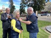 Goulburn Rotary Club president, Steve Ruddell, surprised the council's road safety officer, Tracey Norberg, with a Paul Harris Fellowship on Wednesday, April 24. Mayor Peter Walker watches on. Picture by Louise Thrower.