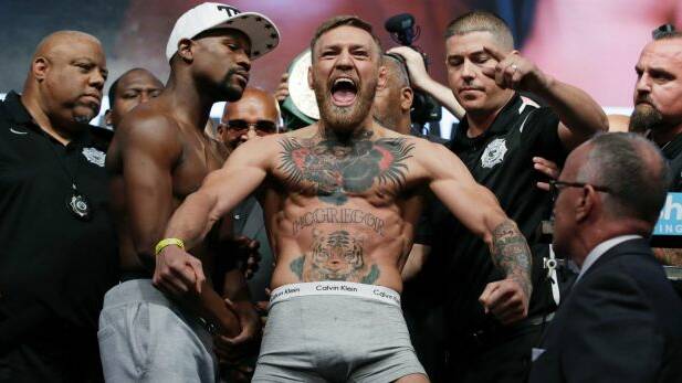 Bring it on: Conor McGregor eats up the spotlight in the weigh-in for his bout against Floyd Mayweather. Photo: JOHN LOCHER