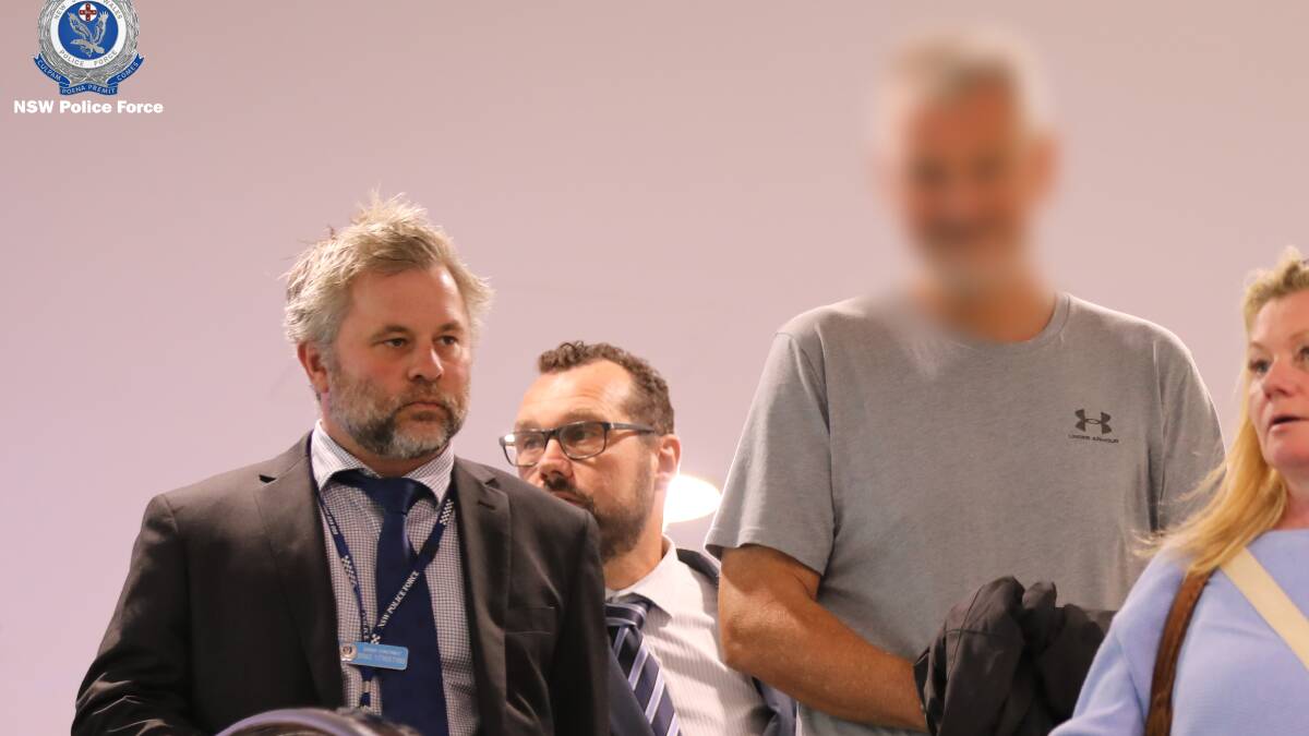 A man at Sydney Airport with detectives following his extradition from Queensland. Picture supplied by NSW Police Force