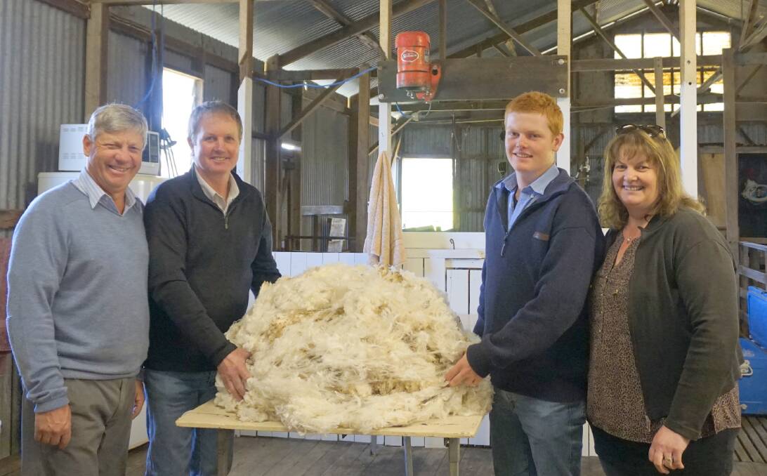 Top sire secured: Danny Picker alongside Lindon, Garth and Jenni Sanders with the fleece from the top-priced ram they purchased at the Hillcreston Park Superfine Merino Stud on-property sale on October 15. Photo: Supplied