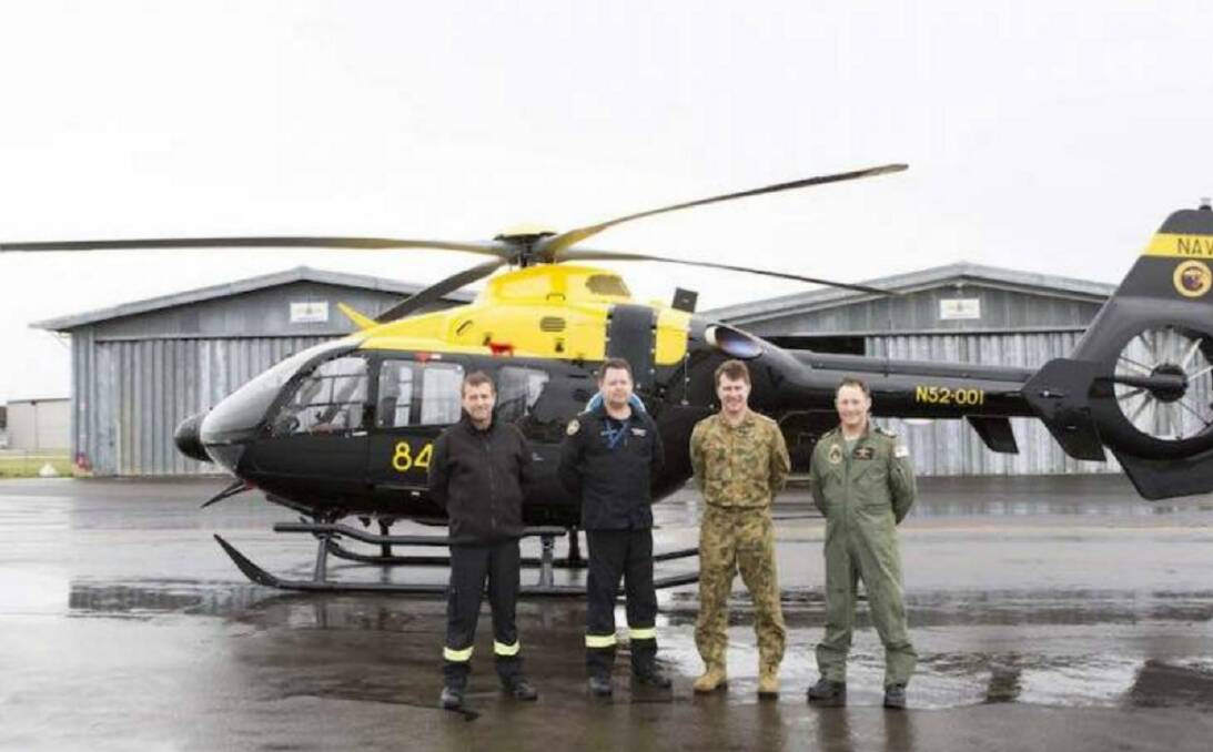 NEW MACHINE: Tim Leonard, Rob Starks, Major Anton Leshinskas and Lieutenant Commander Tony Hammond in front of the EC-135T2 Helicopter after conducting flight trials at HMAS Albatross. Photo: Sarah Ebsworth