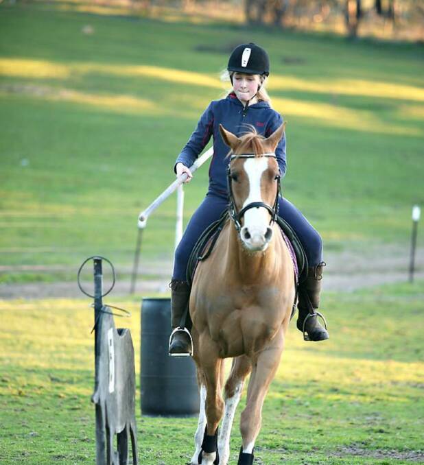 FLYING THE FLAG: Yass Pony Club member Lily Godding, 13, will be the first Australian junior at the prestigious Haras Cup in Texas, US, in October. Pictured is Lily in training with her horse, Linc. Photo: Yass Pony Club.