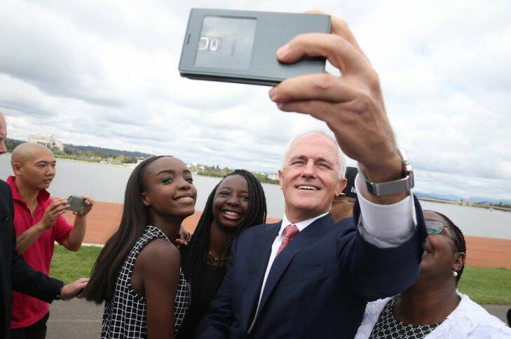 Prime Minister Malcolm Turnbull takes a selfie with new Australian citizens Lydia Banda-Mukuka and Chilandu Kalobi Chilaika after the citizenship ceremony  on Australia Day in Canberra on Tuesday 26 January 2016. Photo: Andrew Meares Photo: Andrew Meares