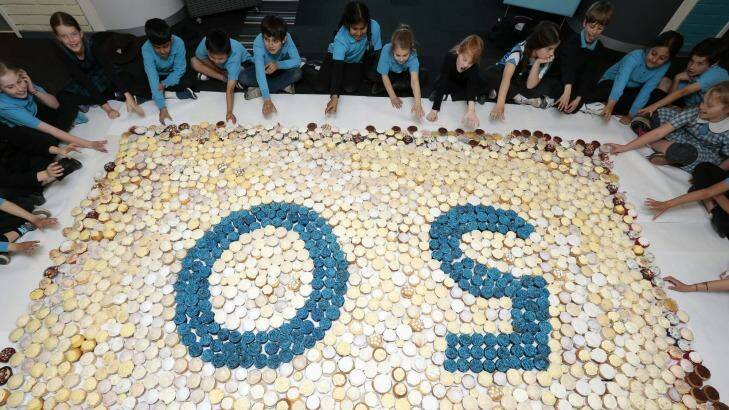 Sweet milestone: Hughes Primary School year 3 students tuck into over 1500 cup cakes that formed a 50 cupcake mosaic as part of the school's 50th birthday celebration. Photo: Jeffrey Chan