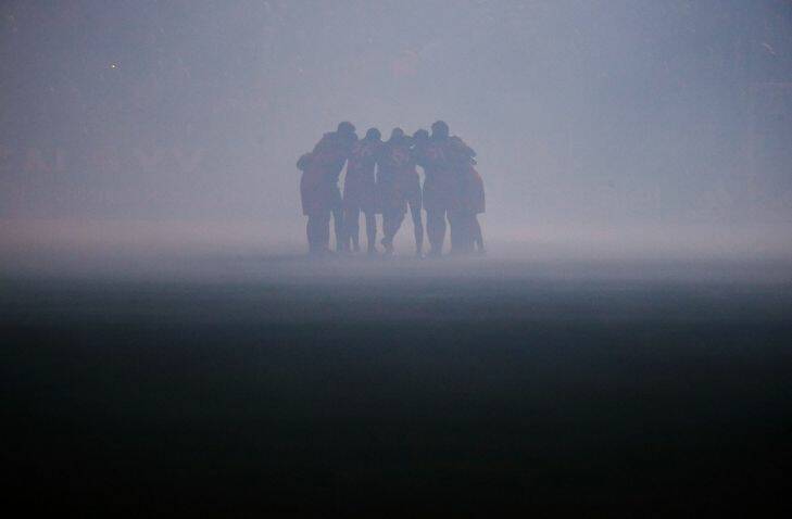 Toronto FC players gather on the smoke-filled field before the team's MLS soccer match against the Los Angeles Galaxy on Saturday, Sept. 16, 2017, in Carson, Calif. (AP Photo/Jae C. Hong)