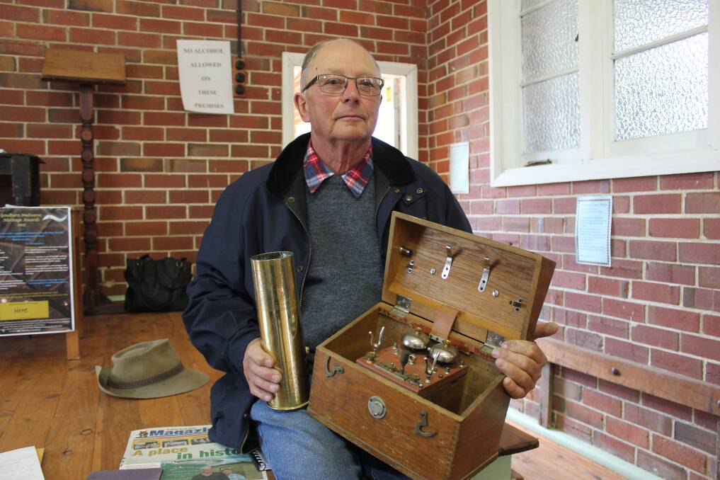 FAMILY MEMORIES: Ian Weatherstone from the village of Parkesbourne, 22km south west of Goulburn holds a shell casing dating from 1911 that belonged to his father Walter Frederick Weatherstone along with a telegraph box used to send messages out on the battlefront. Mr Weatherstone was just one of a few people with interesting stories to tell about their family members who fought in World War One.