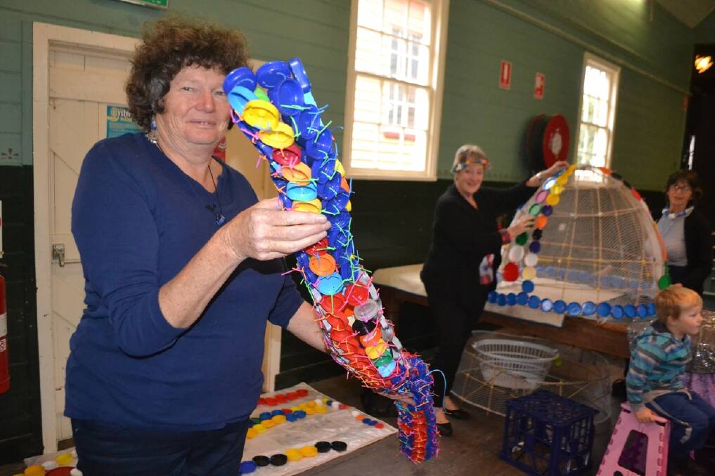 RECYCLED ART: Making items out of recycled materials for the upcoming Narooma Oyster Festival on May 2 are Dorothy Noble (foreground), Judy Glover and Vivienne Bowe- Wood at the Tilba Festival.