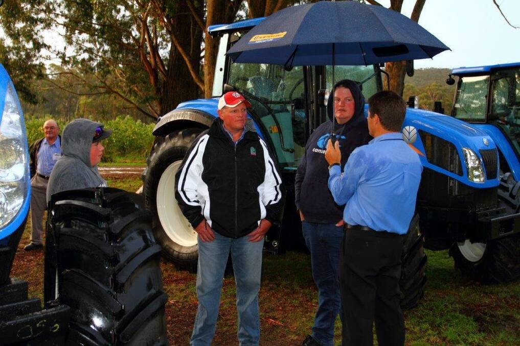 Local farmers discuss the New Holland tractor range with Claude Murray from Southern Highlands Truck and Tractor during the Open Day.