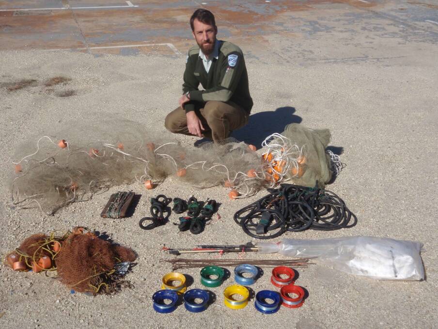COLLECTION: DPI District Fisheries Officer, Joe Wright from Inverell with a collection of lines and nets seized by officers over the June long weekend. 