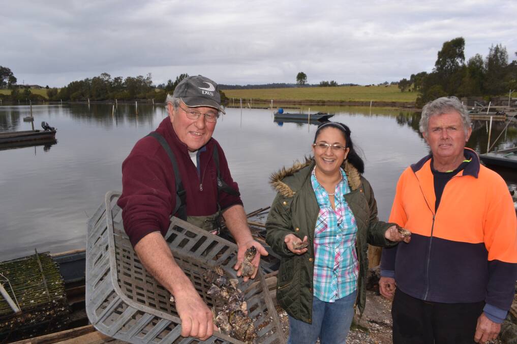TALKING OYSTERS: Narooma Oyster Festival manager and chamber of commerce president, Orit Karny-Winters (centre) chats with oyster growers David Maidment and John Ritchie about the upcoming festival.