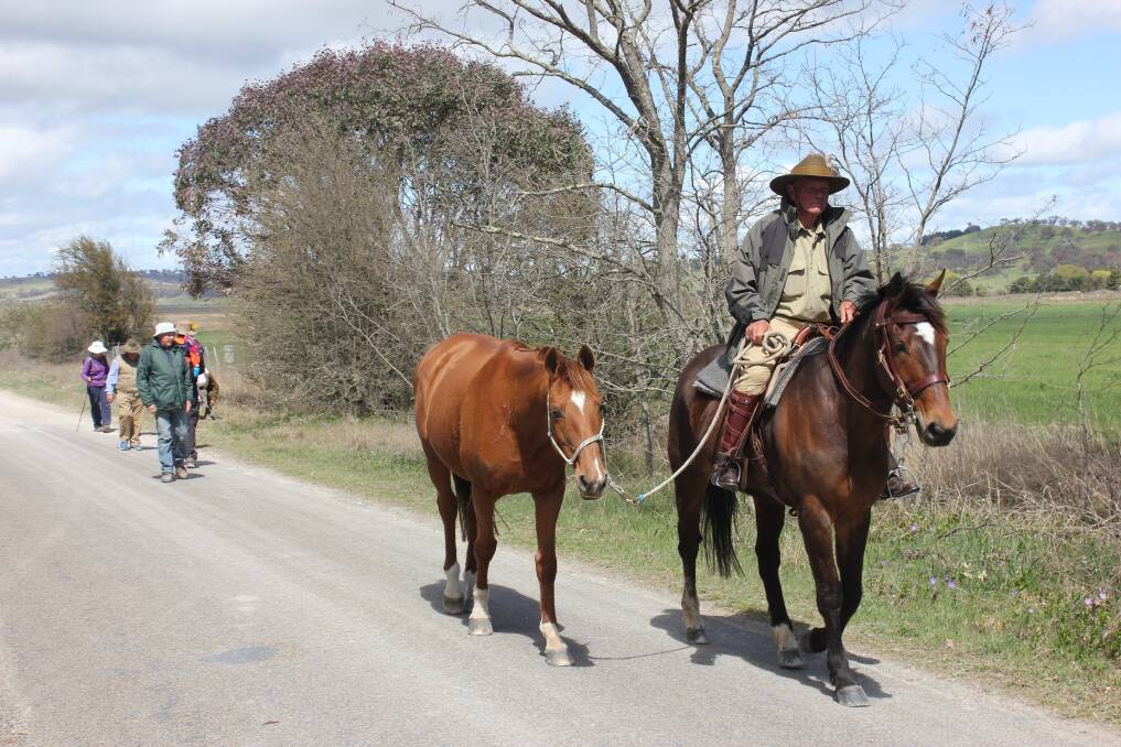 WELCOME: Ken Hughes rides into Parkesbourne on his horse ‘Bubba' with a few Kangaroo Marchers trailing along behind.