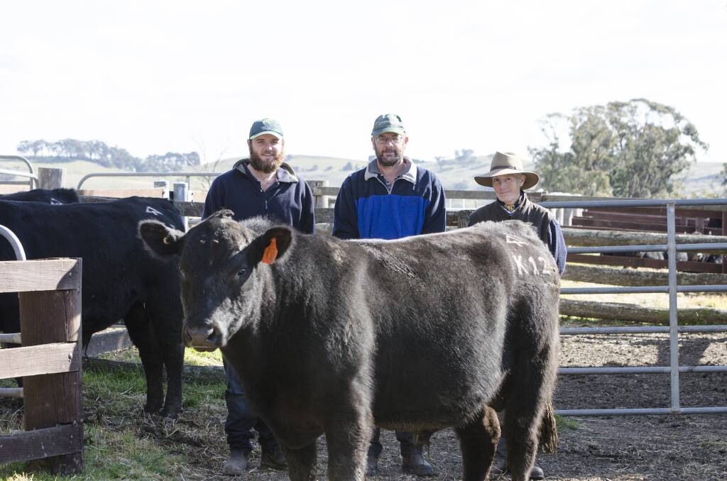 WINNER: Ian Stephenson, Manager Wicklow Properties Taralga, his son Adam who manages the bull unit, and Ingrid Orfali, Co-Principal, The Pines Pastoral with the highest growth bull of the sale, a young yearling bull The Pines Kenneth K12, son of SAV Thunderbird.