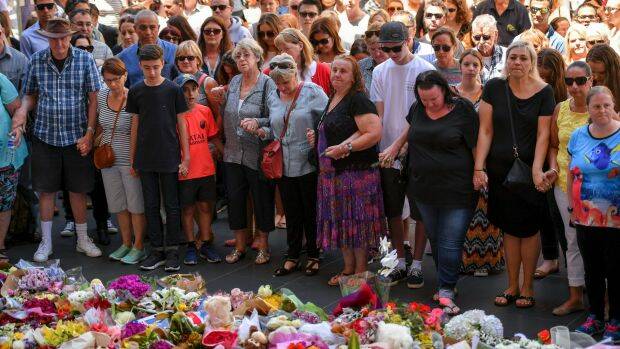 Mourners gather at the makeshift memorial for the Bourke Street tragedy. Photo: Eddie Jim
