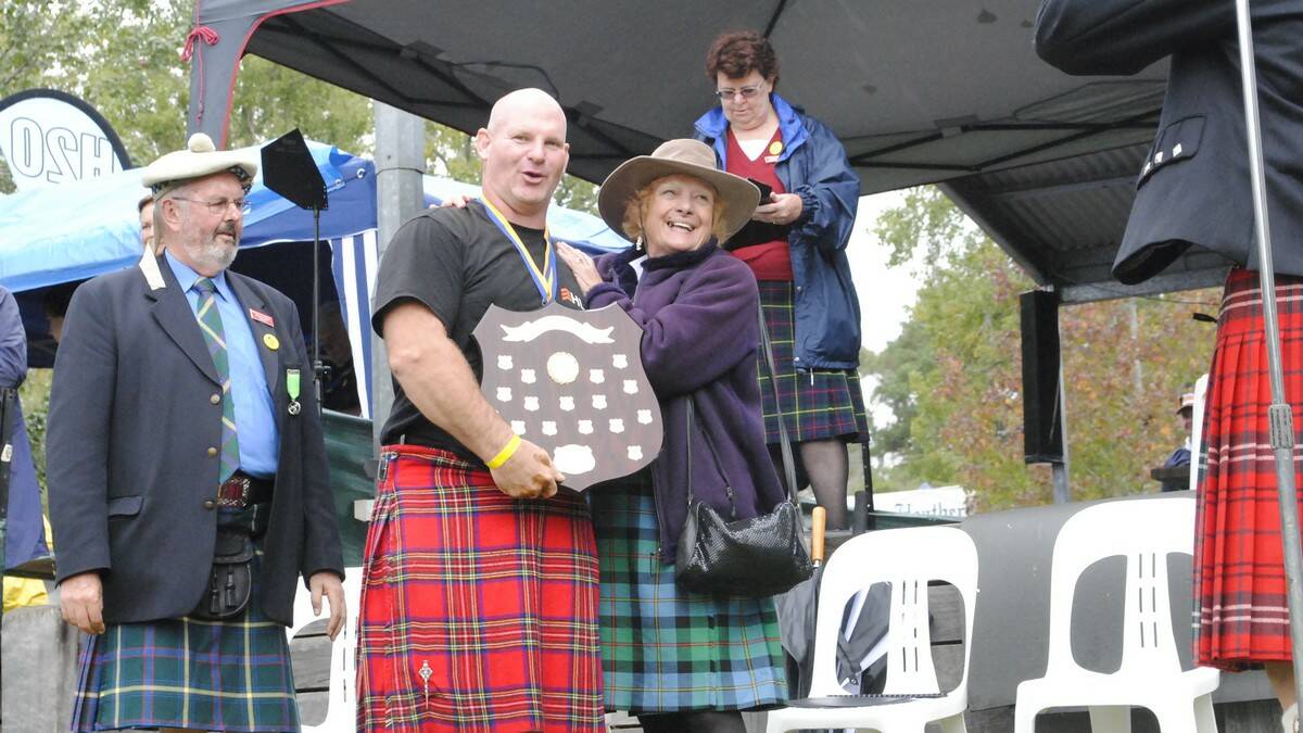 Lee Mitchell is awarded male champion by Chieftain of the Day Valerie Cairney. Photo by Megan Drapalski