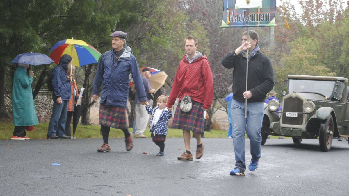 Bruce McLennan, Matilda, 2, and Mark McLennan and Peter Roper march proudly despite the rain. Photo by Megan Drapalski