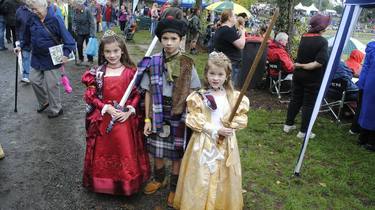 Laura, 7, Marcus, 10, and Bronwynm, 7, show off their costumes and swords. Photo by Dominica Sanda