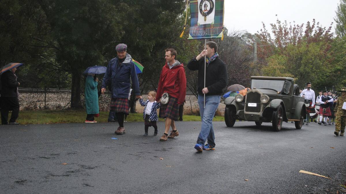 Bruce McLennan, Matilda, 2, and Mark McLennan and Peter Roper march proudly despite the rain. Photo by Dominica Sanda