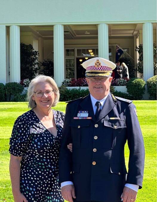 Brian White with wife, Kerry Hort, on the grounds of Government House after receiving his Ambulance Service Medal. Picture supplied.