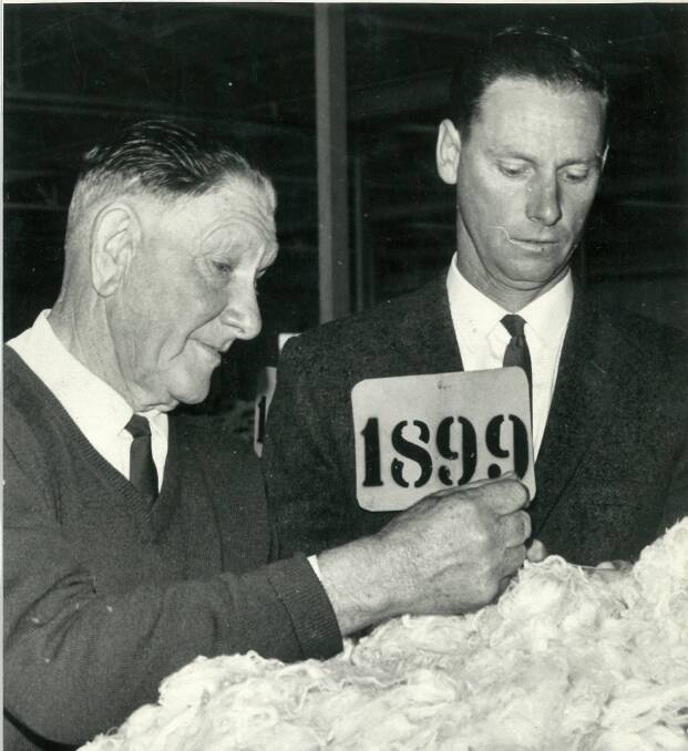 A young Trevor Picker with father Sam at a wool sale. Photo: Leon Oberg.