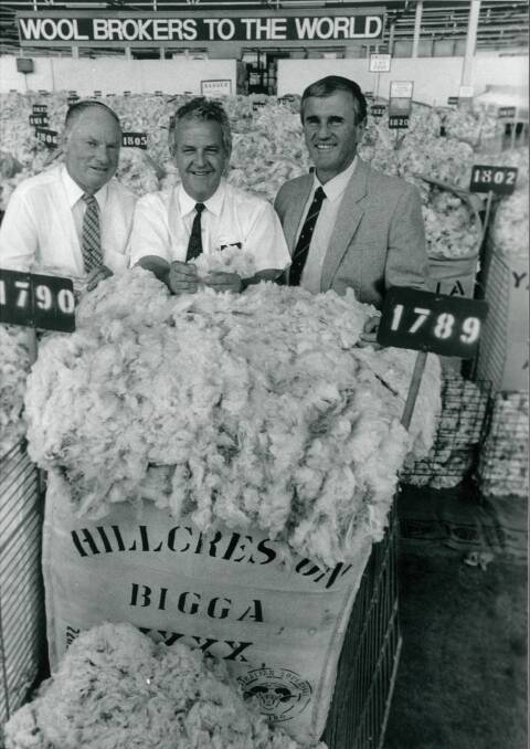 Ray Moroney (right) auctioned much of Hillcreston's wool throughout his working life at Farmers and Graziers and its successors. Hillcreston principal Trevor Picker is pictured left with Ken Woodfull, representing Melbourne based buyer Fujii Keora. Photo: Leon Oberg. 