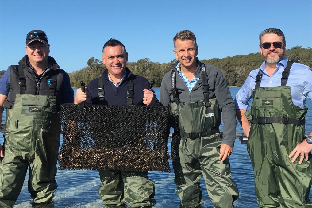 CATCH: Deputy Premier John Barilaro and Treasurer Andrew Constance show off the haul with members of Australia's Oyster Coast.