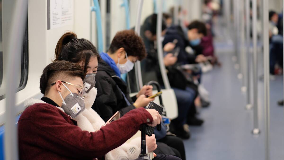  New type coronavirus pneumonia in Wuhan has been spreading into many cities in China. People wearing surgical mask sitting in subway in Shanghai. Photo: Shutterstock