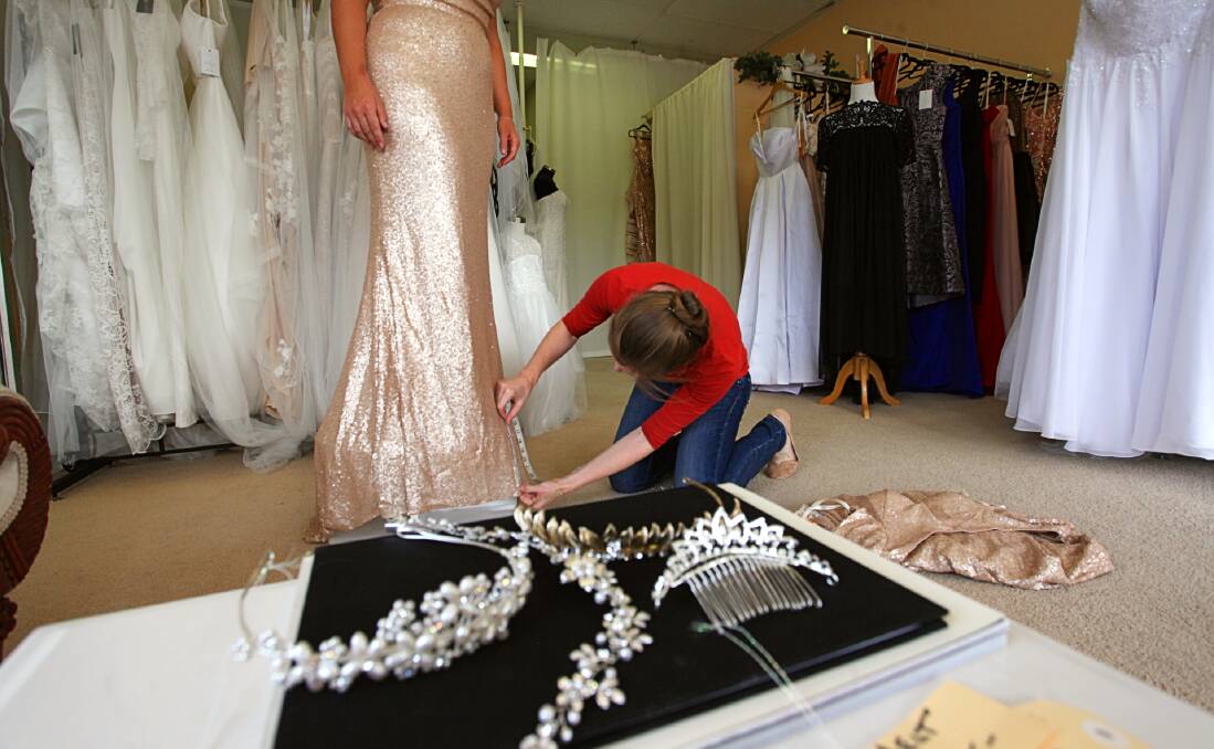 It's not all white: A bride to be has her dress fitted by Carla Ellwood at CC Bridal in Pambula. All things wedding will be at this weekend's bridal fair in Merimbula. Photo: Rachel Mounsey