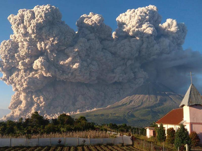 Mount Sinabung spews ash above Karo in North Sumatra, Indonesia.