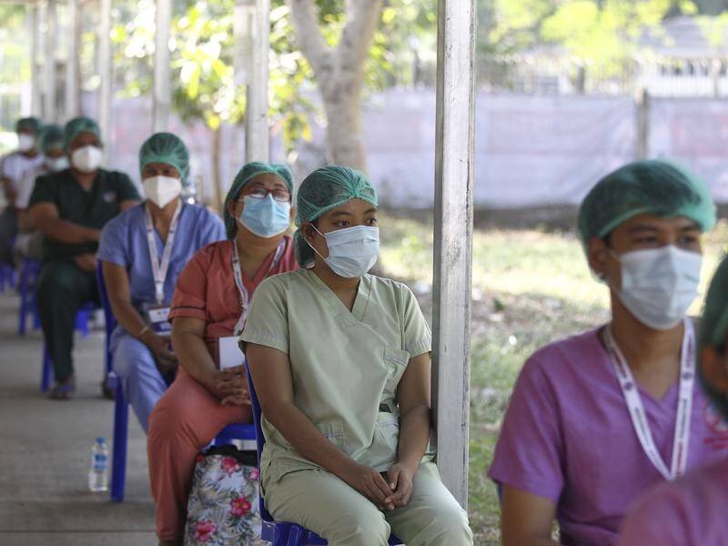 Health workers wait to receive their COVID-19 vaccine at the Ayeyarwady treatment centre in Myanmar.