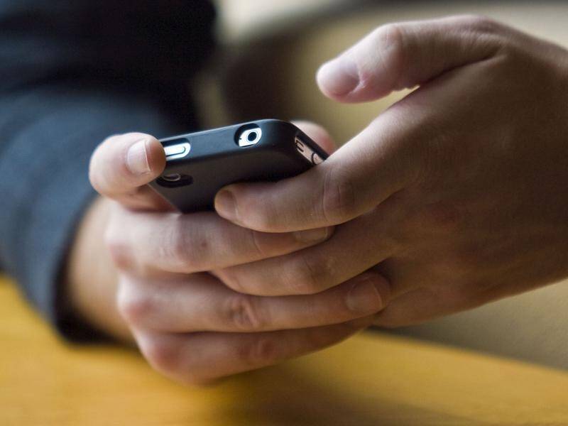 The federal government is looking to follow Victoria's lead and ban mobile phones in school hours.