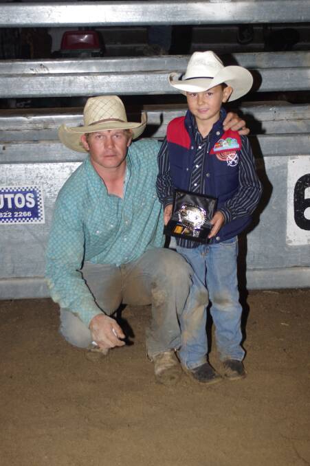 Winner of the Ben Burch Memorial Buckle bull riding event, Tim Amey with Ben's grandson Cooper Burch. 