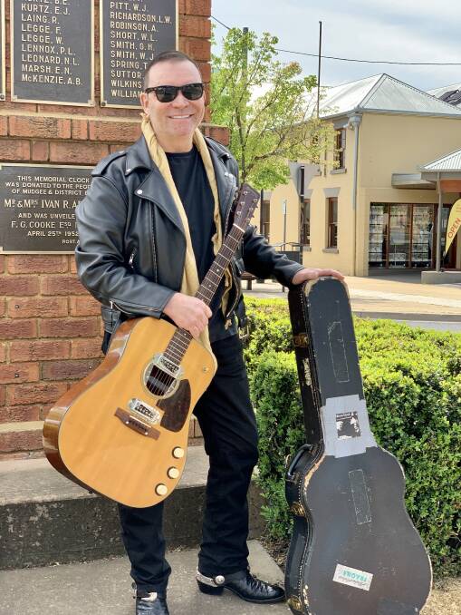 ROCKER: Peter Freedman AM posed with the legendary piece of memorabilia at the Church Street clock recently. Photo: Benjamin Palmer