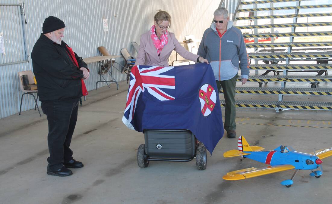 REVEAL: Alan Roberts, Steph Cooke and Grahame James at the unveiling of the generator for the Cootamundra Aeromodellers Association. Photo: Declan Rurenga